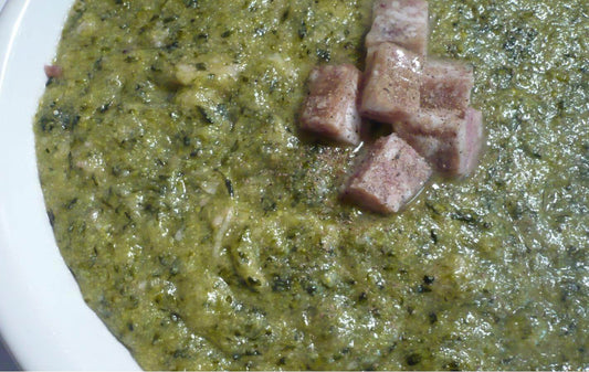 Close-up of Calabrese polenta with broccoli and ciccioli, showcasing a hearty, traditional dish.