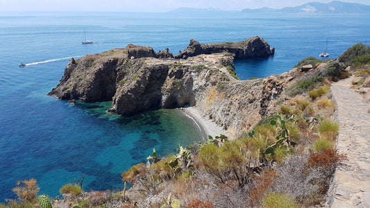 Stunning view of Panarea, the smallest Eolian island, showcasing crystal-clear waters and rocky coastline.