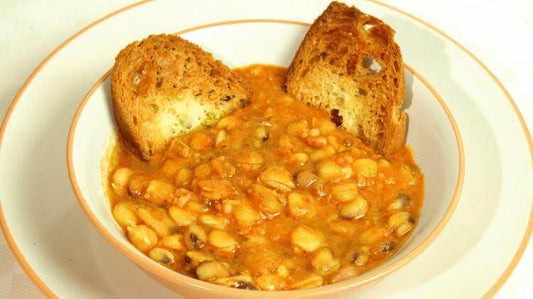 Bowl of cicerchia soup served with toasted bread slices, showcasing a rustic Italian dish.