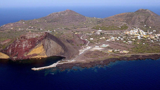 Aerial view of Linosa Island showcasing its volcanic landscape and coastal village.