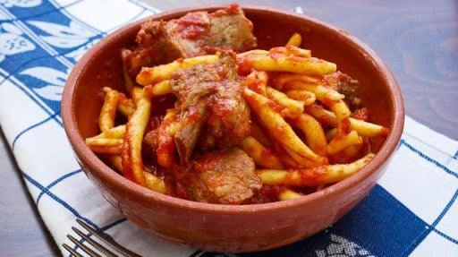 Bowl of Fileja pasta with meat in tomato sauce, traditional dish from Calabria, Italy.