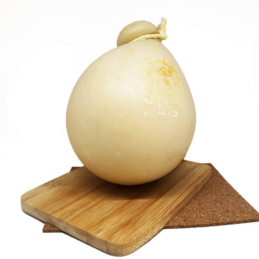 Provola aromatica cheese on a wooden board, showcasing its unique round shape and traditional presentation.