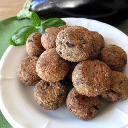 Delicious ricotta balls arranged on a plate, garnished with basil leaves.