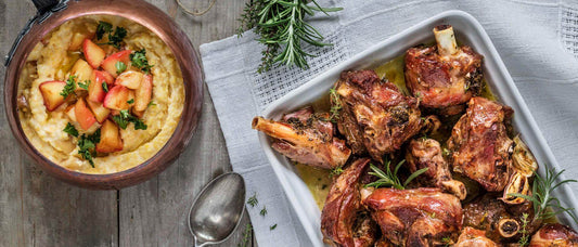 Delicious roasted capretto served with creamy polenta and garnished with fresh rosemary.