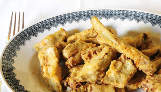 Delicious fried artichokes served on a decorative plate, perfect for a Calabrian dish.