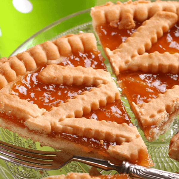 Slice of Crostata Argianale with Bergamot jam served on a glass plate, perfect for breakfast or snack.