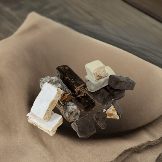 Torrone di Bagnara Calabra assorted nougat pieces on brown fabric.
