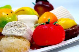 Colorful assortment of Sicilian Martorana fruit sweets, showcasing intricate almond-based desserts.