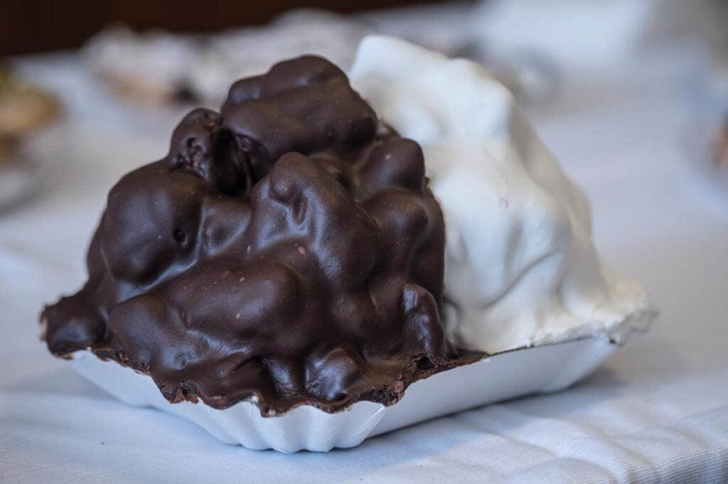 Pignolata Storica Messinese: lemon pastry pieces covered in white and chocolate glaze, typical of Sicilian Carnival.