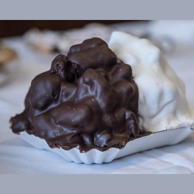 Pignolata Storica Messinese: lemon pastry pieces covered in white and chocolate glaze, typical of Sicilian Carnival.