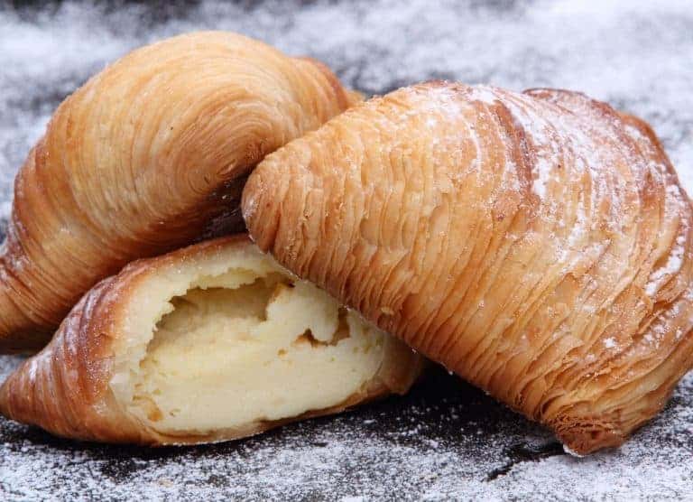 Sfogliatella Riccia: flaky Neapolitan pastry filled with sweet ricotta, perfect for indulgent moments.
