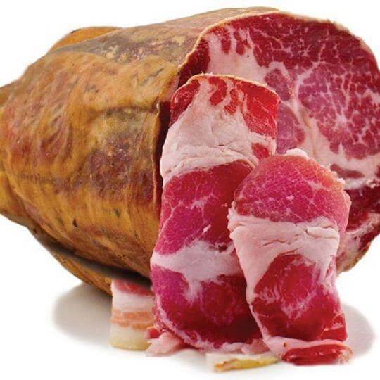 Capocollo al Vino Nero di Troia sliced showcasing marbled texture and rich color.