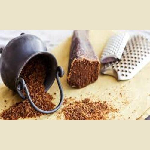 Bottarga di Tonno - Grattugiata in a black bowl, with a grater and a block of bottarga, showcasing Mediterranean culinary tradition.