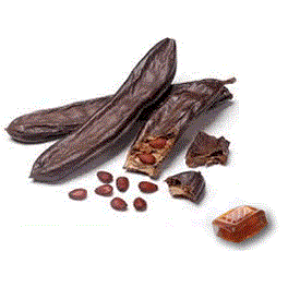 Caramelle di Carruba siciliane with carob pods and seeds on display, highlighting traditional Sicilian confections.