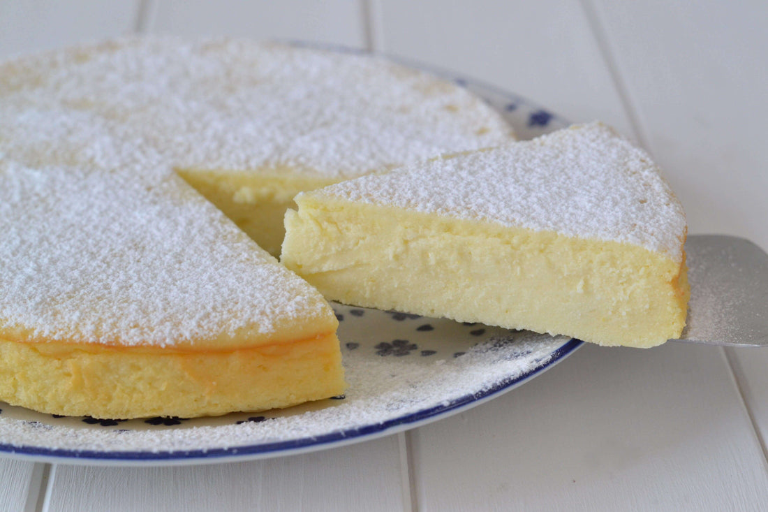 Delicious torta di ricotta, a creamy ricotta cake dusted with powdered sugar, with a slice cut out.