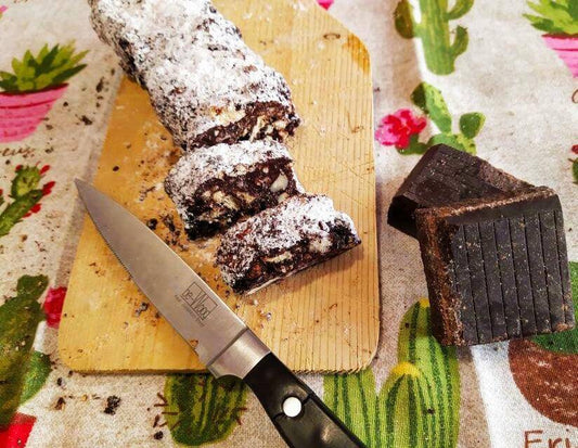Delicious sliced Salame di Cioccolato on a cutting board, showcasing rich chocolate and nut textures.