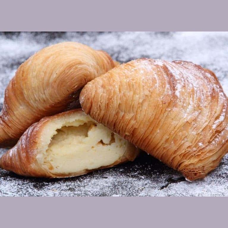 Sfogliatella Riccia: flaky Neapolitan pastry filled with sweet ricotta, perfect for indulgent moments.